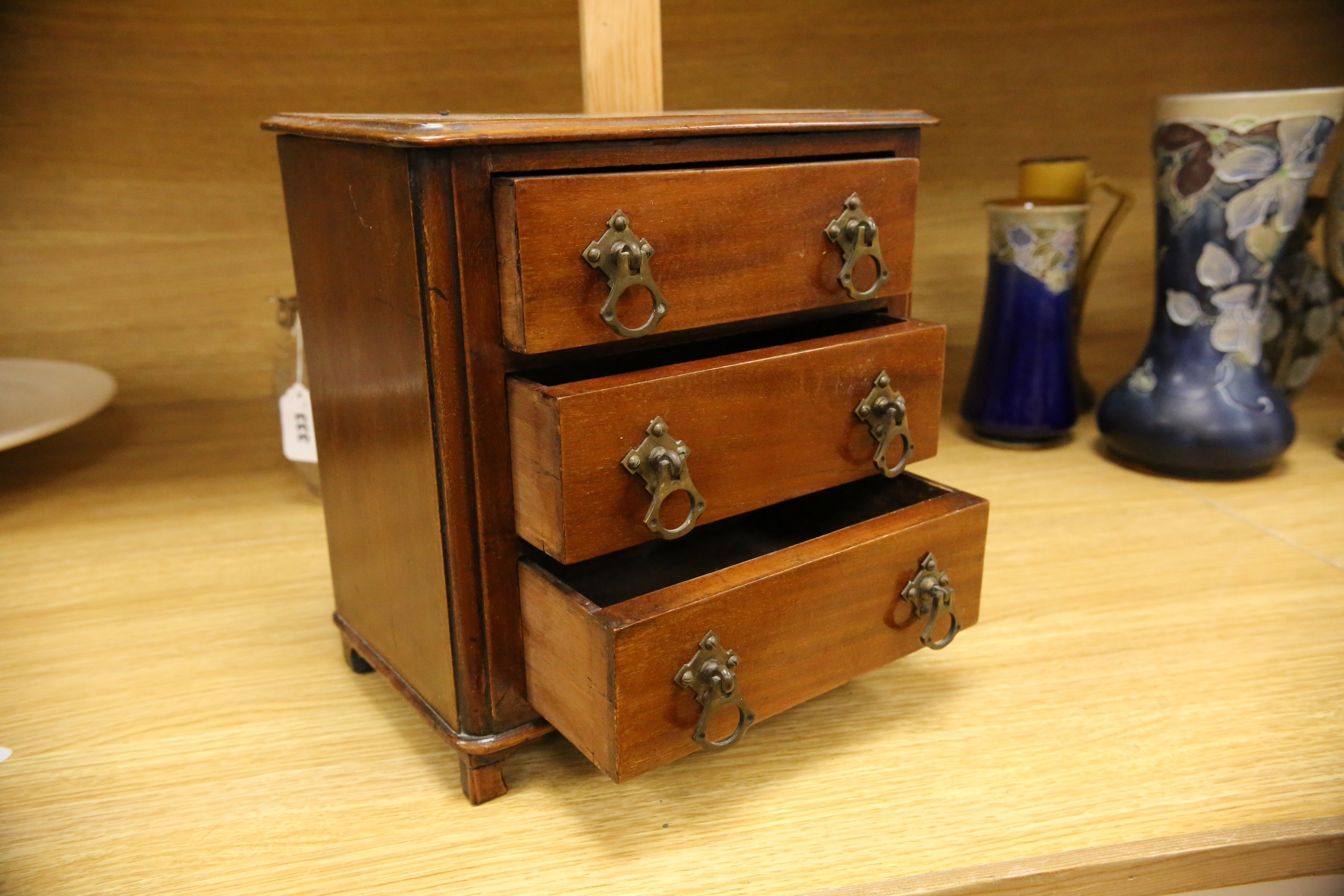 An Edwardian miniature mahogany three drawer chest, 26cm wide x 28cm high. Condition - fair to good